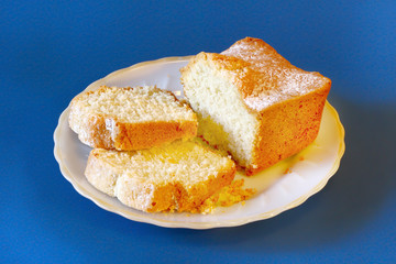 delicious fresh cupcake on a plate on a blue background