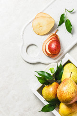 Ripe pears in white wooden box on rustic background. Top view, space for text.