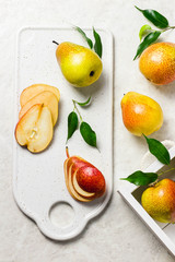Ripe pears in white wooden box on rustic background. Top view, space for text.