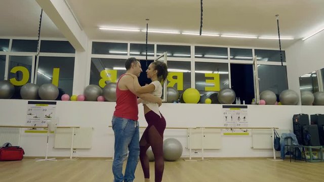 Man and woman dacing in latino style. Professional dancers