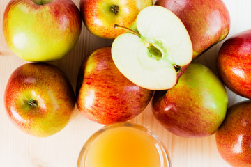 Glass of fresh apple cider near autumn apples