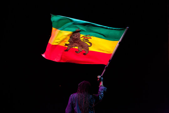 black man waving jamaica flag