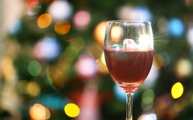 Glass of cocktails closeup blur Christmas tree lights decoration background