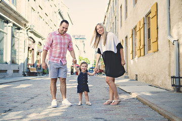 Fototapeta premium Parent and child girl having fun on old city street