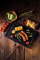 grilled krakauer with french fries and green salad