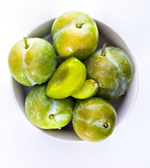 Delicious green plums fresh and raw claudias. Isolated on white background.