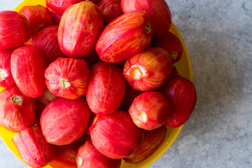 Whole Peeled Tomatoes in Yellow Bowl.