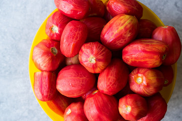 Whole Peeled Tomatoes in Yellow Bowl.