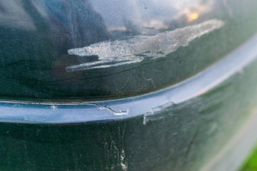 Naklejka na ściany i meble A crack on the bumper of the car. A shabby car bumper. A road accident.