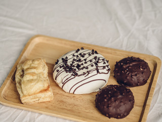 Set of chocolate donuts and puff pie.