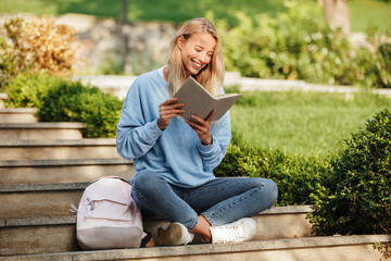 Portrait of a cheerful young girl student with backpack