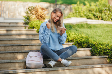 Portrait of a satisfied young girl student with backpack