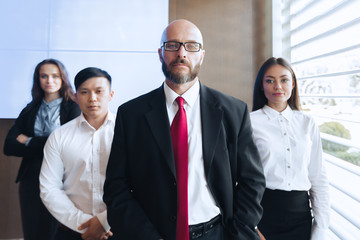 Group portrait of a professional business team looking confidently at camera