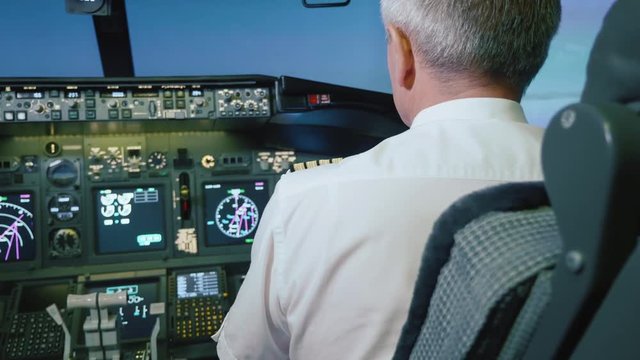 Captain is controls the airplane, rear view.