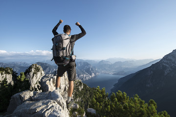 Hiker at the top of the trekking trail with a beautiful lake view