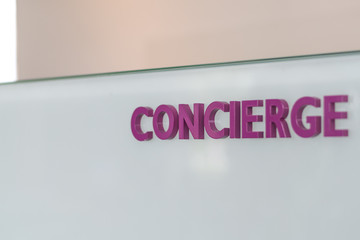 Concierge service desk counter with staff team working in front of hotel with tourist business customer.