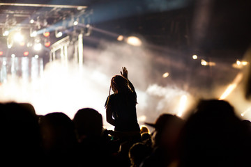 cheering crowd with raised hands at concert - music festival