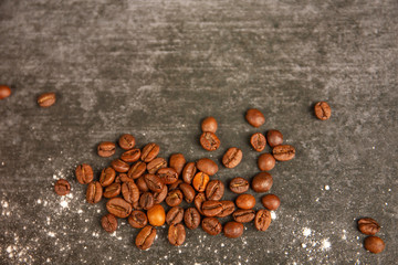 coffee grains lie a gray stone background