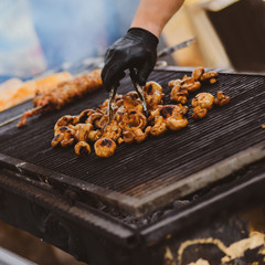 Closeup photo of fresh mushrooms cooking outdoor on grill