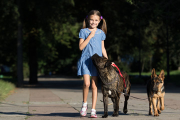 girl and dog walking in the park