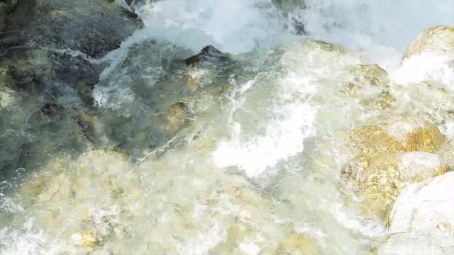 SLOW MOTION Watching a waterfall on a hike in Auron, France.