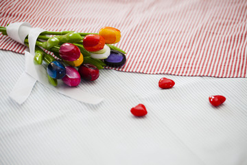 Nine wooden tulips of different colors and hearts

