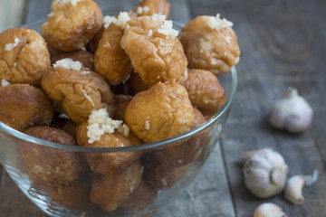 Donuts with garlic on a wooden background.