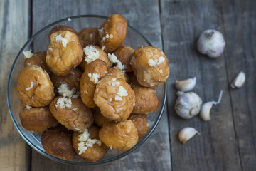 Donuts with garlic on a wooden background.