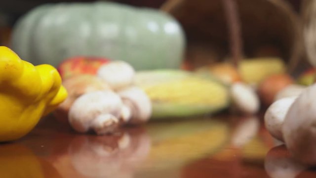 Autumnal Harvest or Thanksgiving, Cornucopia filled with vegetables, vegetables spilled out of the basket on the table. 4k, dolly shot