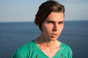 A young guy is resting on the sea.