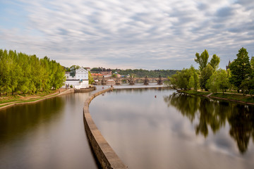 Fototapeta na wymiar Sov's mills on the Vltava River, in the background of Charles Bridge