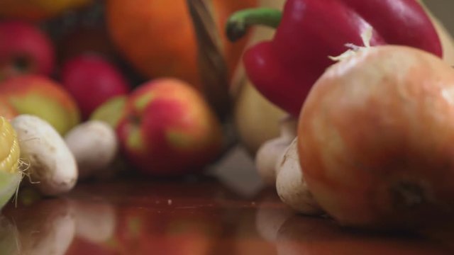 Autumnal Harvest or Thanksgiving, Cornucopia filled with vegetables, vegetables spilled out of the basket on the table. 4k, dolly shot