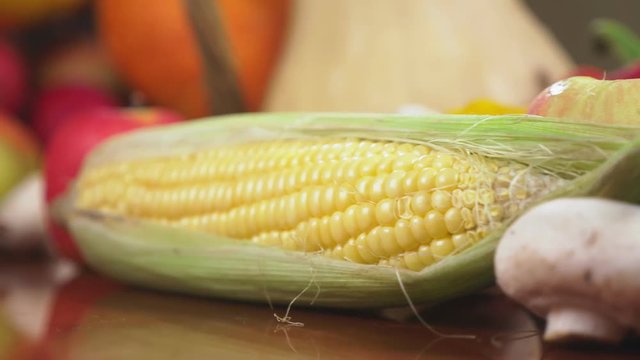 Autumnal Harvest or Thanksgiving, Cornucopia filled with vegetables, vegetables spilled out of the basket on the table. 4k, dolly shot