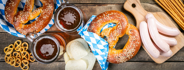 Oktoberfest concept - traditional food and beer on rustic background