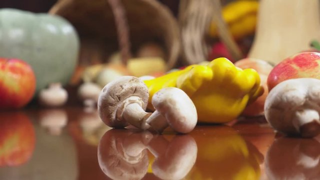 Autumnal Harvest or Thanksgiving, Cornucopia filled with vegetables, vegetables spilled out of the basket on the table. 4k, dolly shot