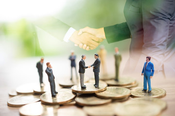 Miniature people standing on coin,Business concept