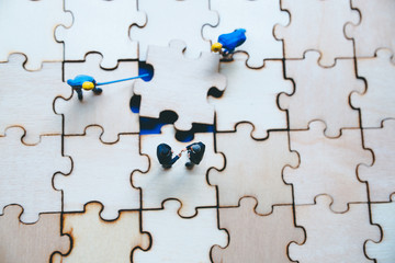 Miniature on wood jigsaw, Business concept