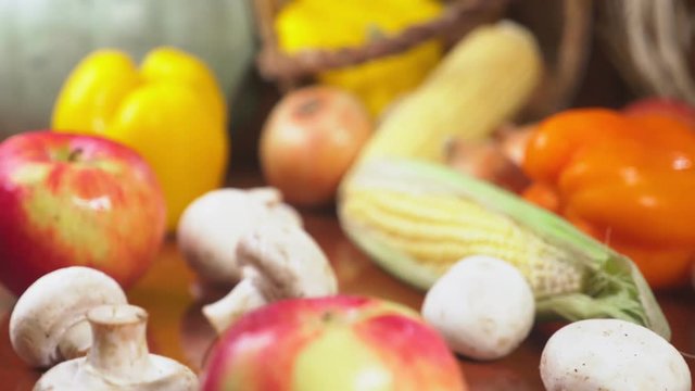 Autumnal Harvest or Thanksgiving, Cornucopia filled with vegetables, vegetables spilled out of the basket on the table. 4k, dolly shot