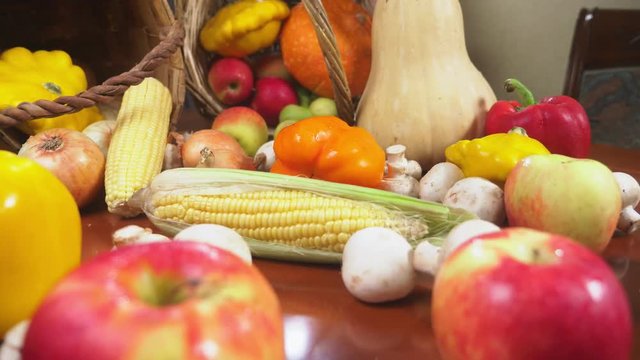 Autumnal Harvest or Thanksgiving, Cornucopia filled with vegetables, vegetables spilled out of the basket on the table. 4k, dolly shot
