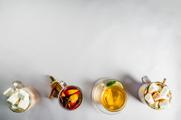 Variations winter autumn traditional drinks - pumpkin latte, hot chocolate, tea with lemon, mulled wine, copy space