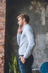 side view of businessman talking on smartphone at home