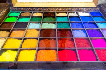 An art  tray full of colourful pigment used to make paints, all colours of the rainbow, color,...