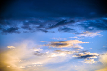 The beautiful abstract complex mixed image of the clouds over the lake of the City Park at the spring sunset