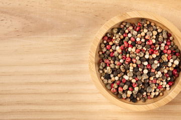 An overhead closeup photo of a mix of various peppers with copy space
