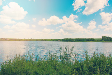 Beautiful blue sky with clouds above the lake