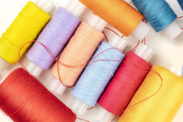 An overhead closeup photo of vibrant thread spools