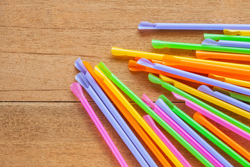 Colorful Straw on wood table background.