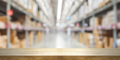 Empty wooden table top with blurred store background.