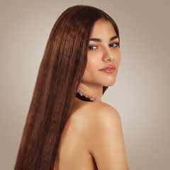 Portrait of a beautiful young woman with luxurious long hair