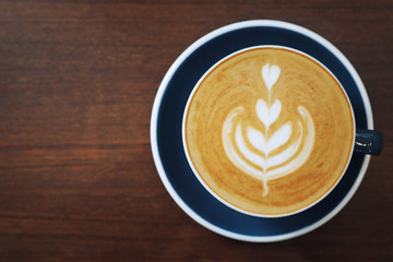 cappuccino or Latte art coffee made from milk on the wood table in coffee shop